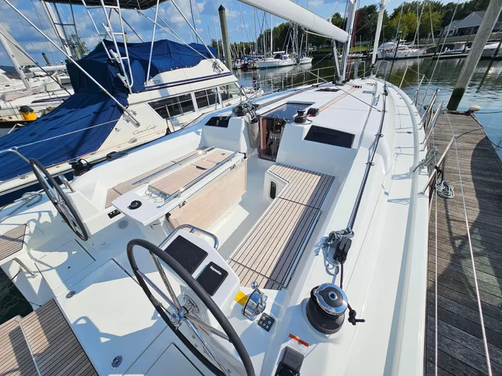  Yacht Photos Pics 2024 Beneteau Oceanis 40.1 sailboat docked, showcasing spacious deck and dual steering wheels.