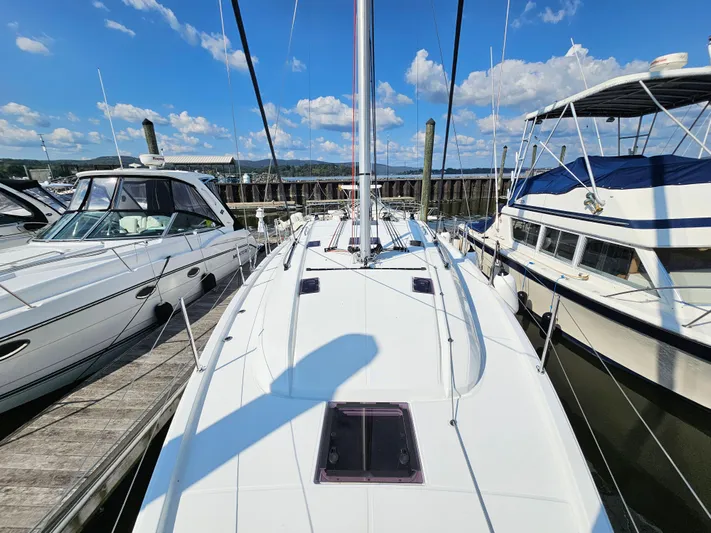  Yacht Photos Pics 2024 Beneteau Oceanis 40.1 sailboat docked, surrounded by other boats under a clear blue sky.