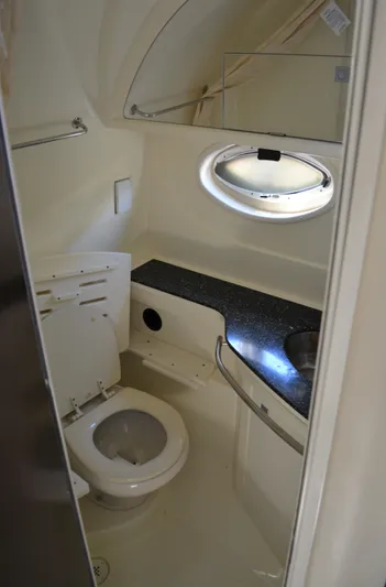 Ruff Life Yacht Photos Pics 2013 Monterey 340 Sport Yacht bathroom with toilet, sink, and porthole window.