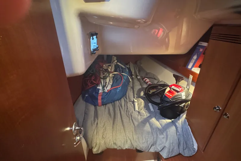 Falcon Yacht Photos Pics Cozy cabin storage in 2004 Dufour 40 Performance sailboat, featuring equipment and supplies.