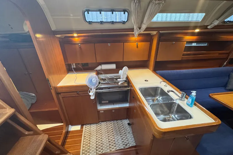 Falcon Yacht Photos Pics Interior of 2004 Dufour 40 Performance yacht with kitchen and seating area.