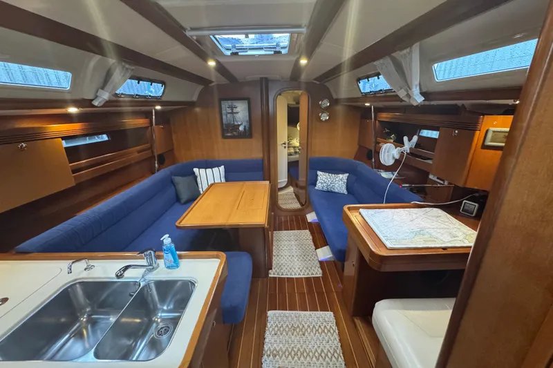 Falcon Yacht Photos Pics Interior of 2004 Dufour 40 Performance yacht with blue seating and wooden finishes.
