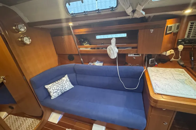 Falcon Yacht Photos Pics Interior of 2004 Dufour 40 Performance yacht with blue sofa and navigation table.
