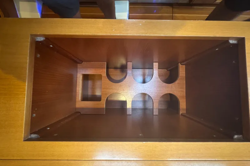 Falcon Yacht Photos Pics Wooden wine rack inside 2004 Dufour 40 Performance yacht, showcasing elegant craftsmanship.