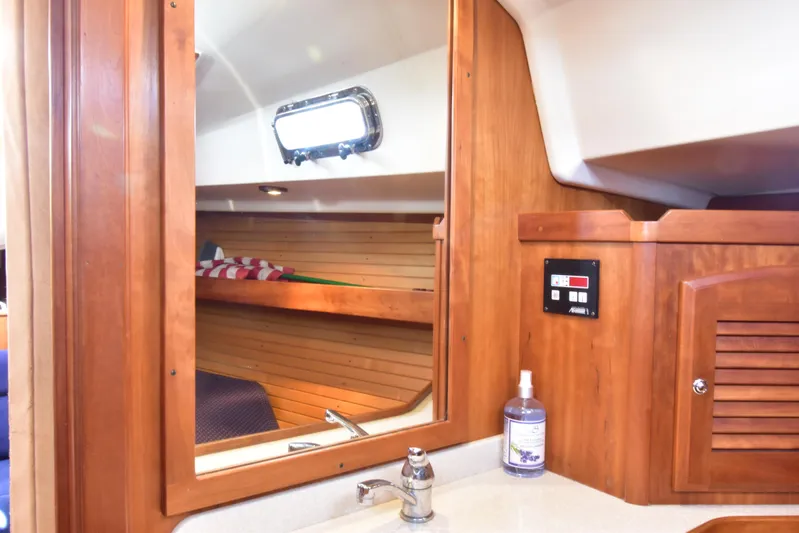 Zia Yacht Photos Pics Interior of 2004 Sabre 386 sailboat with wooden cabinetry and sink area.