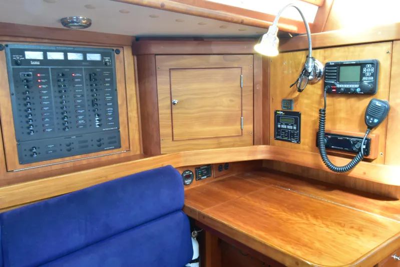 Zia Yacht Photos Pics 2004 Sabre 386 yacht interior with navigation equipment and wooden cabinetry.
