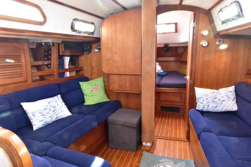 Zia Yacht Photos Pics Interior of 2004 Sabre 386 sailboat with blue seating and wooden finishes.