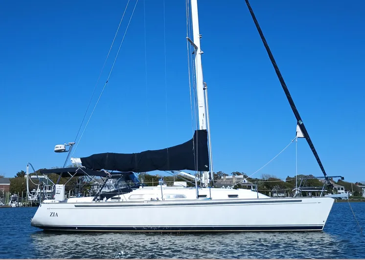 Zia Yacht Photos Pics 2004 Sabre 386 sailboat on calm water under clear blue sky.
