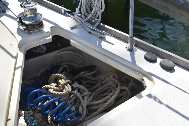 Zia Yacht Photos Pics Storage compartment on 2004 Sabre 386 sailboat with ropes and winch.