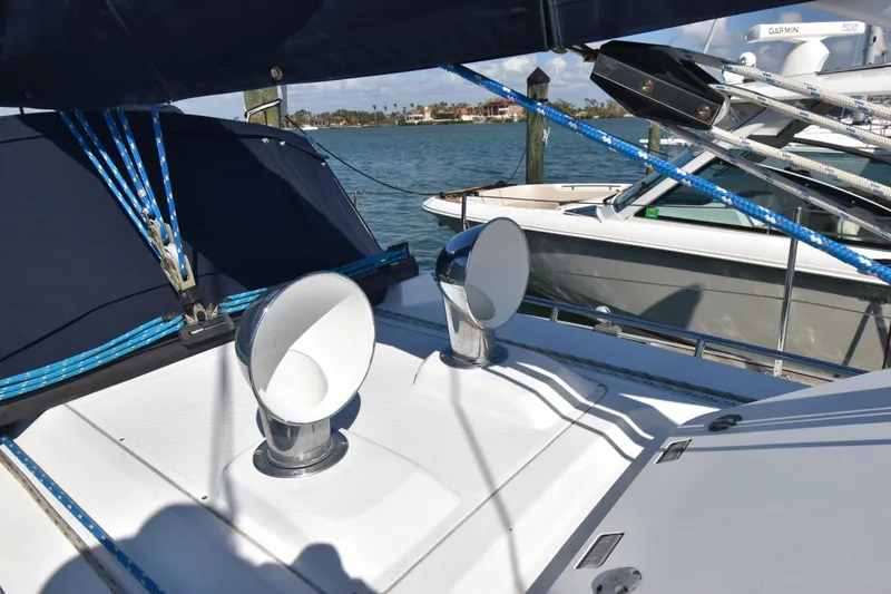 Zia Yacht Photos Pics 2004 Sabre 386 sailboat deck with ventilation cowls and rigging, docked by the water.