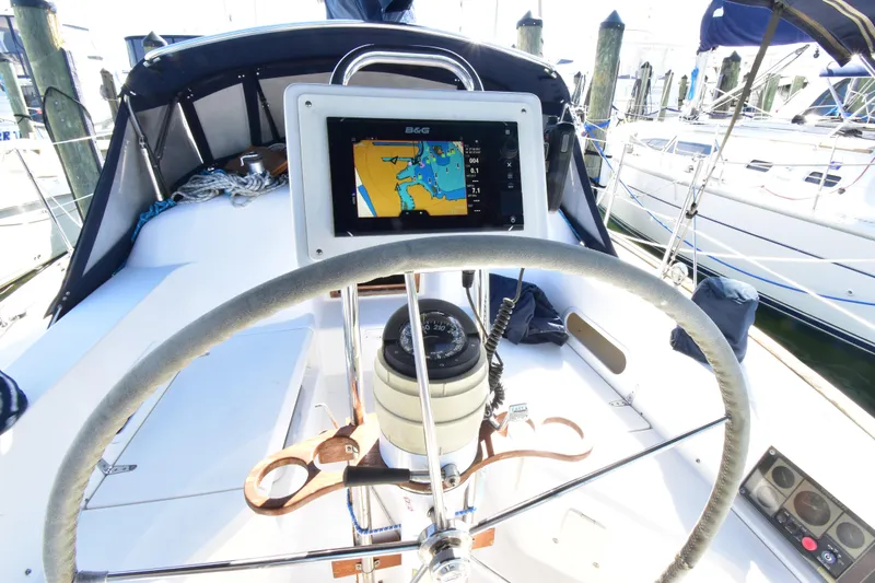 Zia Yacht Photos Pics Steering wheel and navigation system on a 2004 Sabre 386 sailboat at a marina.