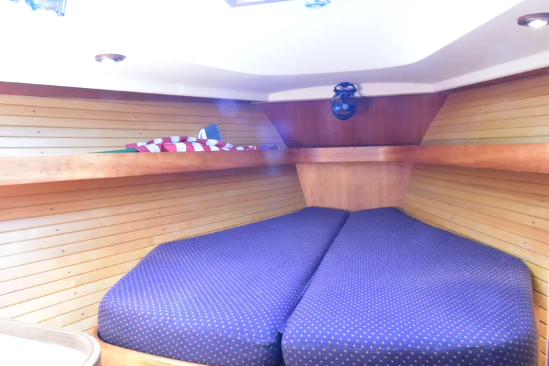 Zia Yacht Photos Pics 2004 Sabre 386 yacht interior with cozy V-berth and wooden paneling.