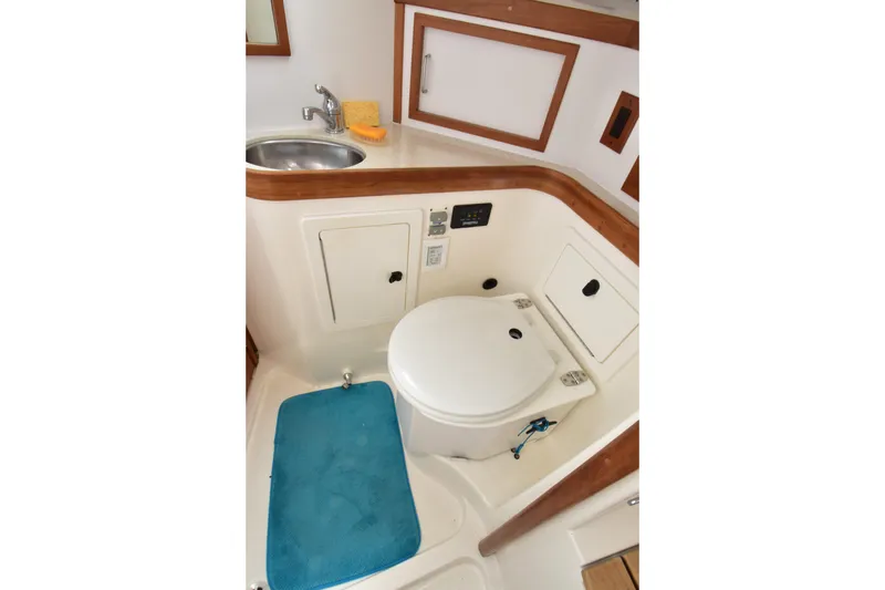 Zia Yacht Photos Pics Compact bathroom in 2004 Sabre 386 yacht with sink, toilet, and storage.