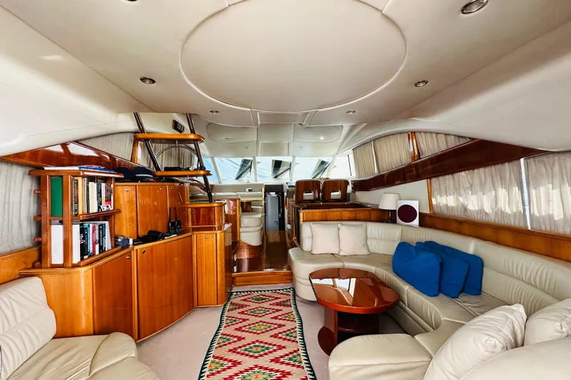  Yacht Photos Pics Luxurious interior of a 2001 Princess 56 yacht with elegant wood finishes and plush seating.