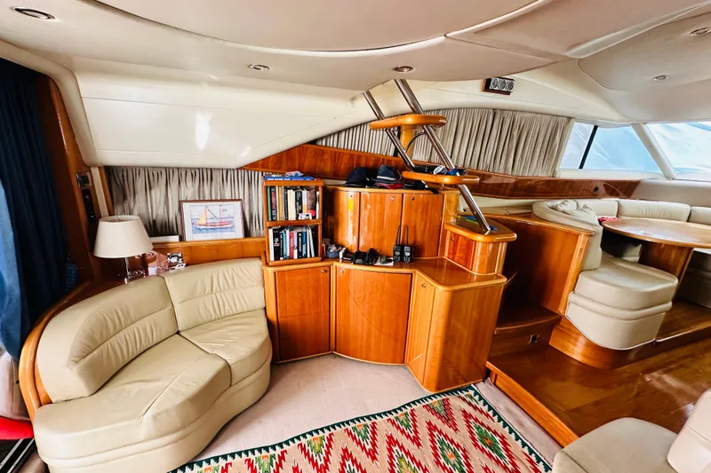  Yacht Photos Pics Luxurious interior of a 2001 Princess 56 yacht with elegant seating and wooden cabinetry.