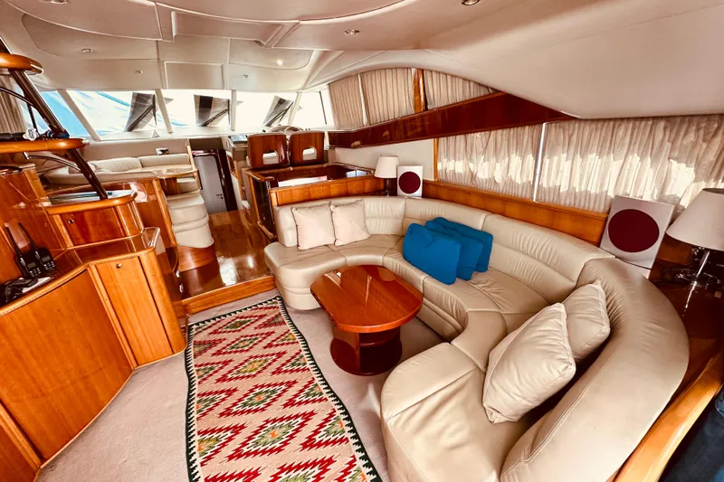  Yacht Photos Pics Luxurious interior of a 2001 Princess 56 yacht with elegant wood finishes and plush seating.