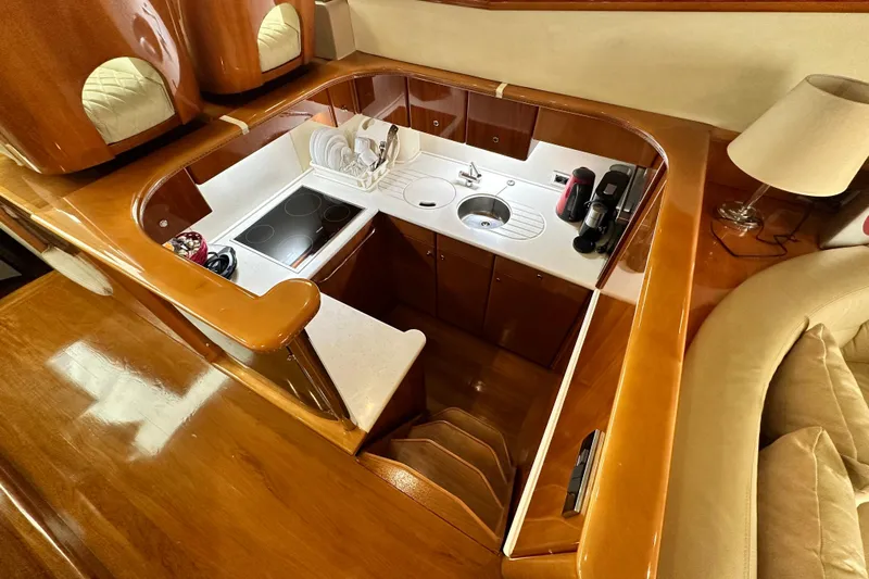  Yacht Photos Pics Luxurious 2001 Princess 56 yacht kitchen with modern appliances and elegant wood finish.