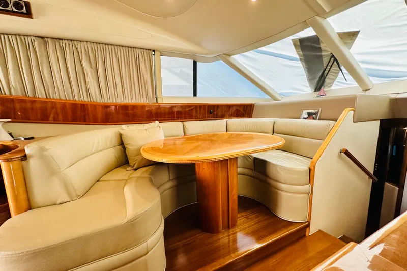  Yacht Photos Pics Luxurious interior of a 2001 Princess 56 yacht with elegant leather seating and wooden table.