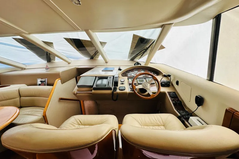  Yacht Photos Pics Interior of a 2001 Princess 56 yacht, featuring a luxurious helm and seating area.