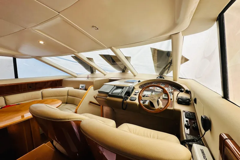  Yacht Photos Pics Luxurious interior of a 2001 Princess 56 yacht, featuring a sophisticated helm and seating area.