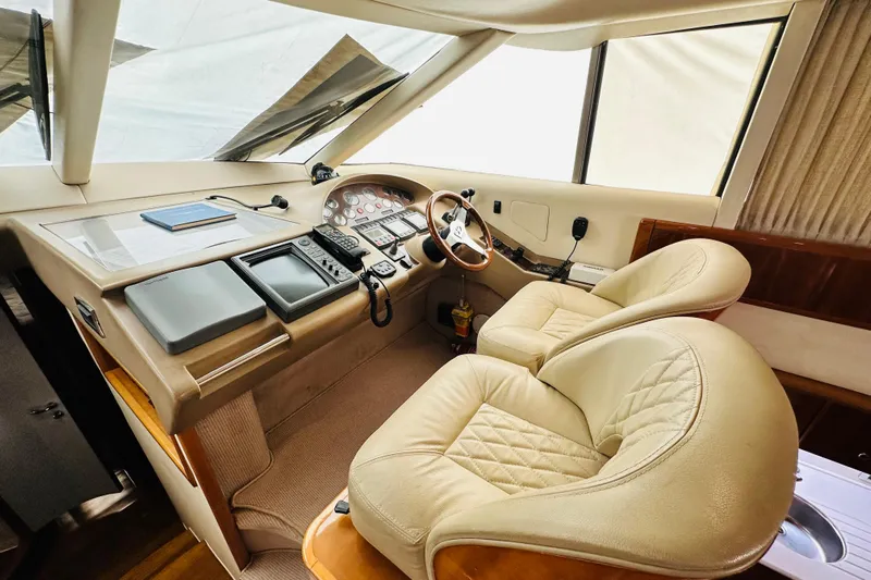  Yacht Photos Pics Luxurious helm of 2001 Princess 56 yacht with leather seats and navigation equipment.