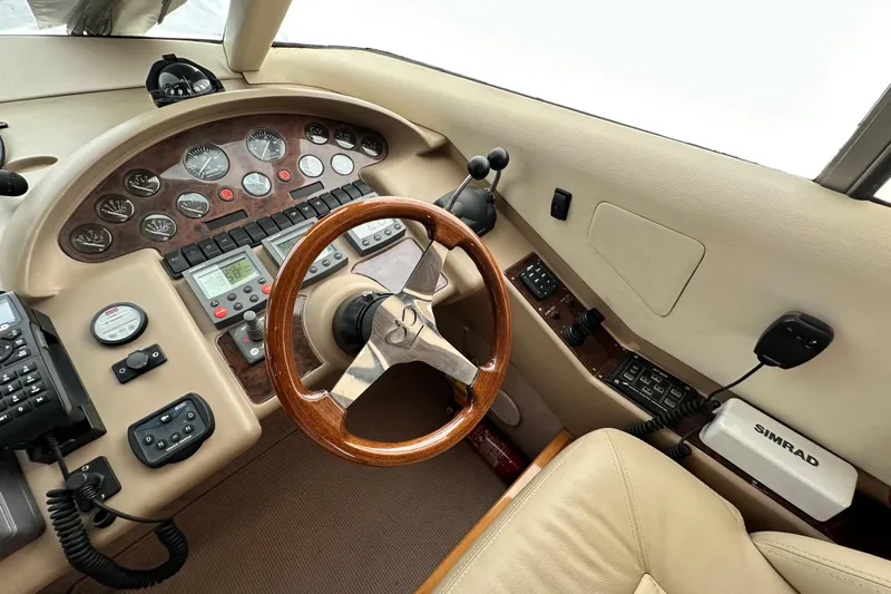  Yacht Photos Pics Helm of 2001 Princess 56 yacht with wooden steering wheel and navigation instruments.