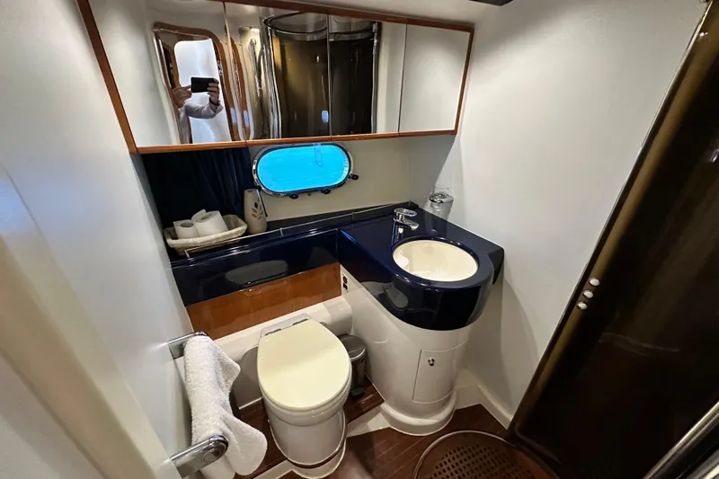  Yacht Photos Pics Luxurious bathroom in 2001 Princess 56 yacht with modern fixtures and porthole window.