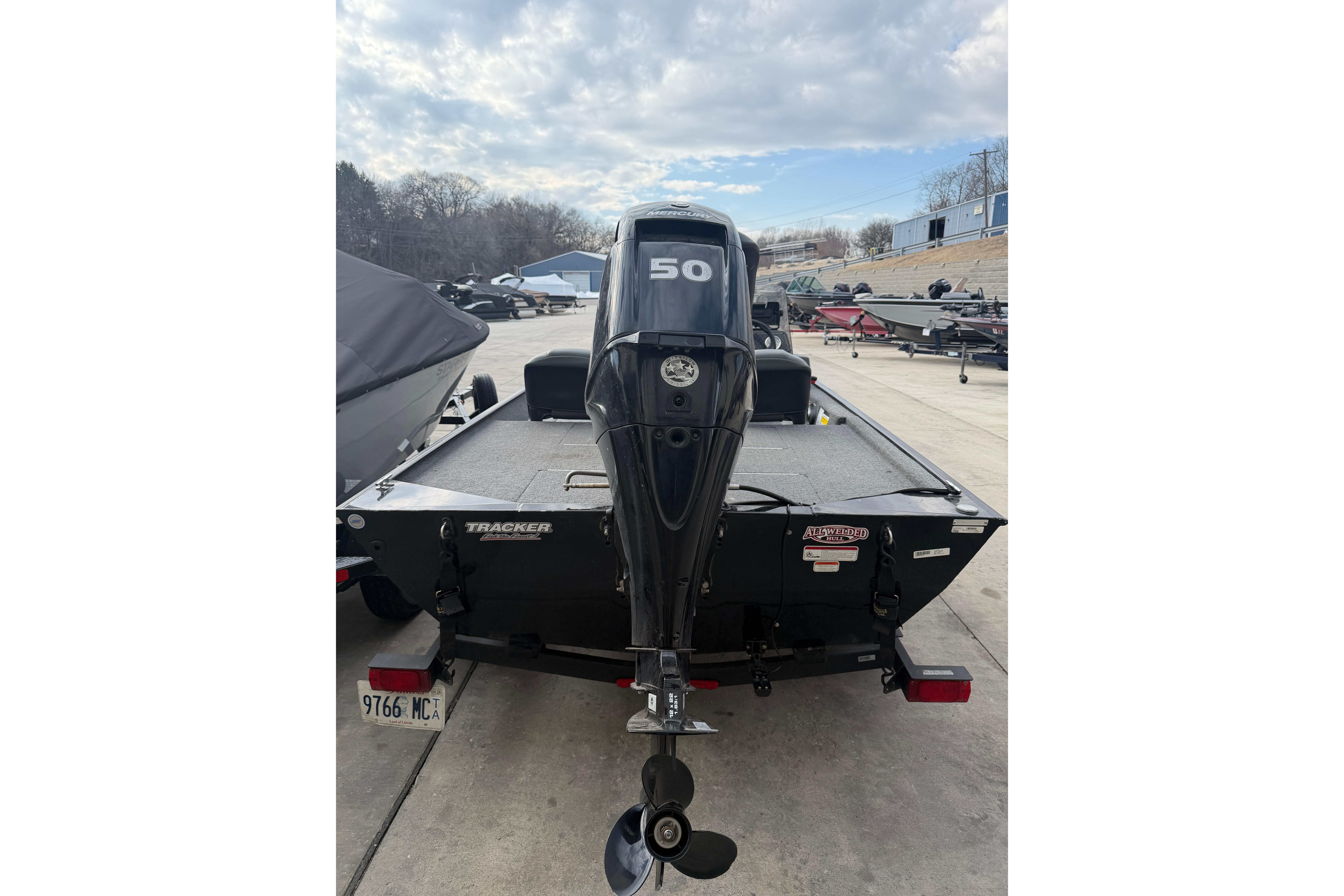 2020 Tracker Bass Tracker Classic XL boat with 50 HP motor, parked outdoors.