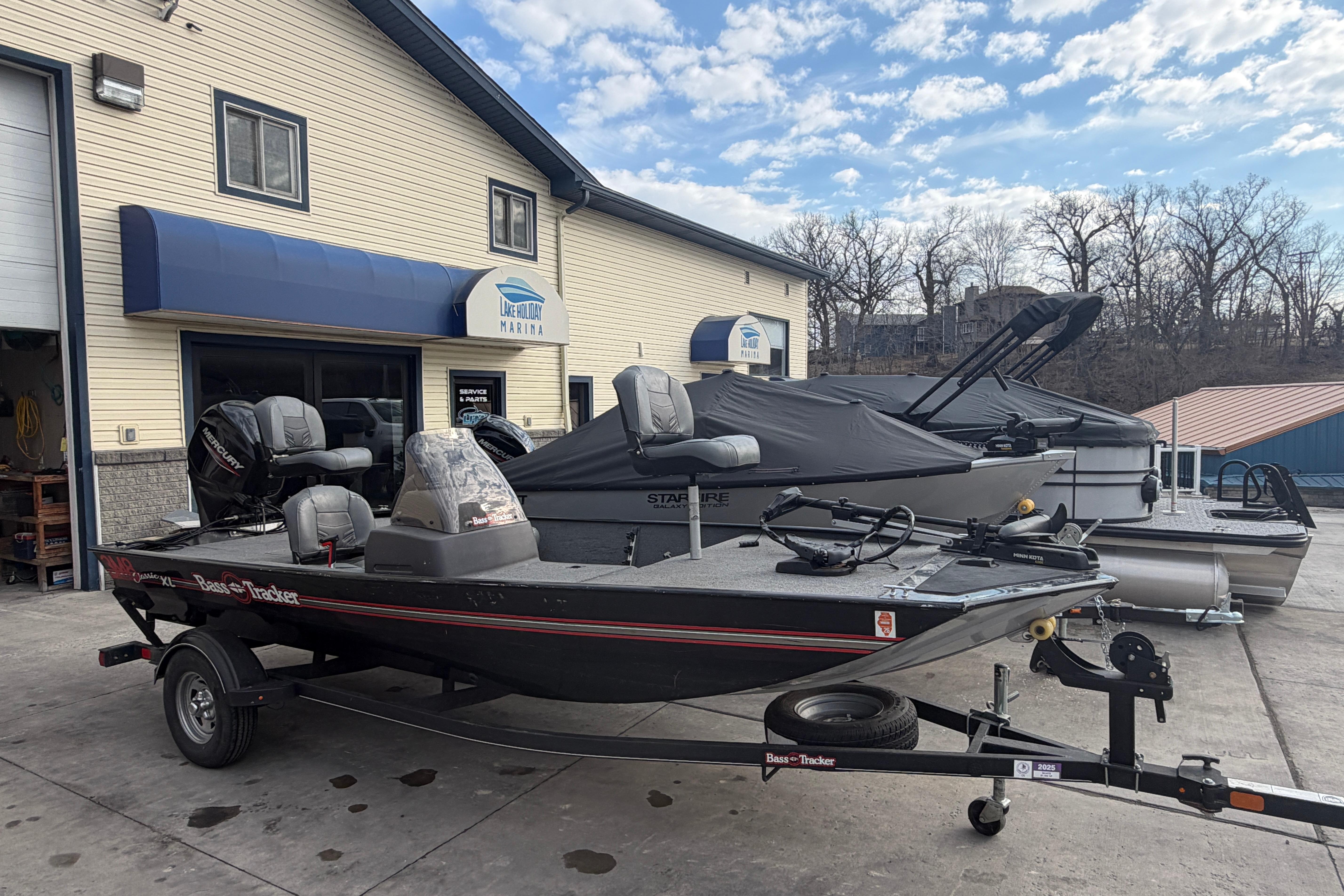2020 Tracker Bass Tracker Classic XL boat at marina, parked on trailer.