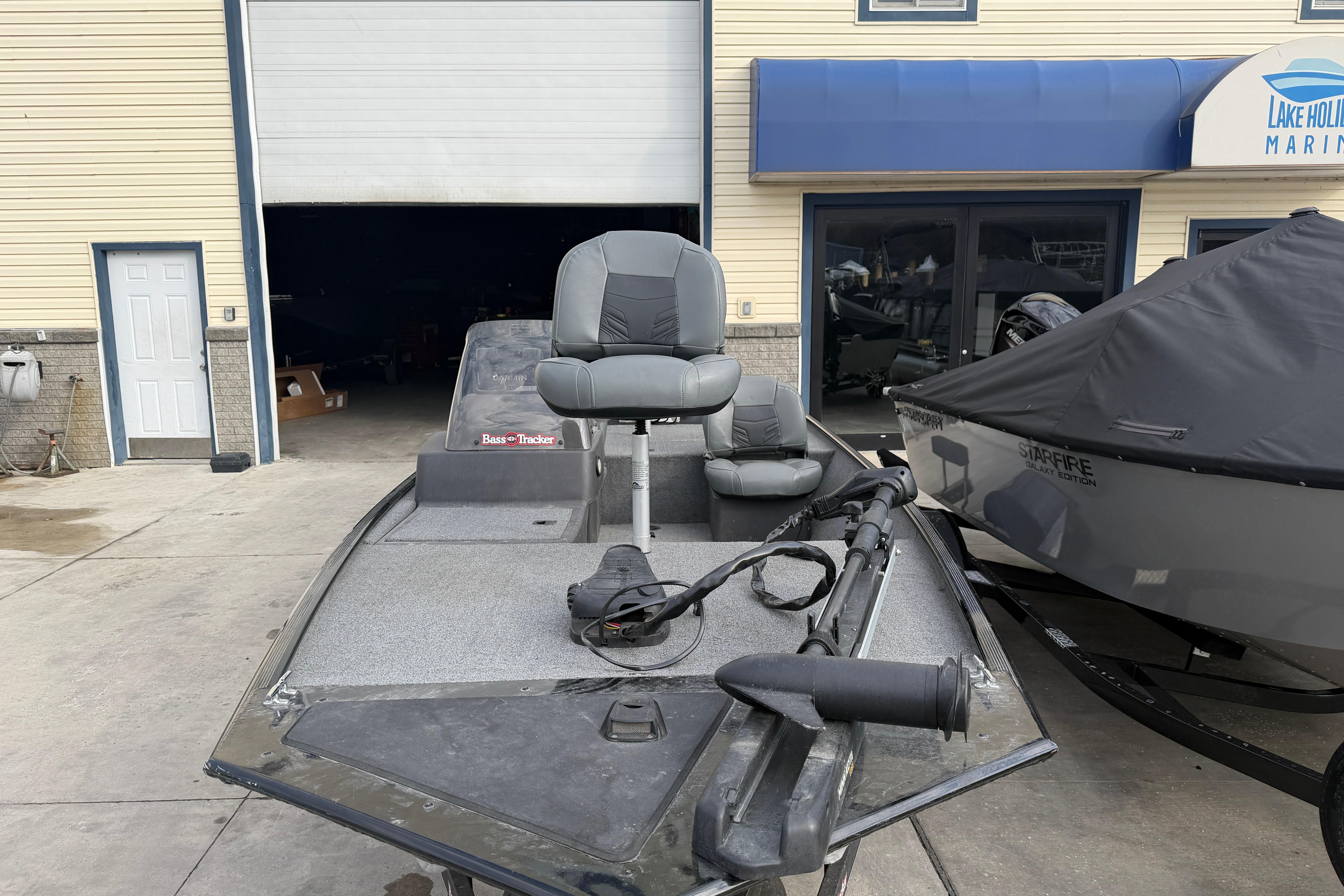 2020 Tracker Bass Tracker Classic XL boat at marina, featuring seating and equipment.