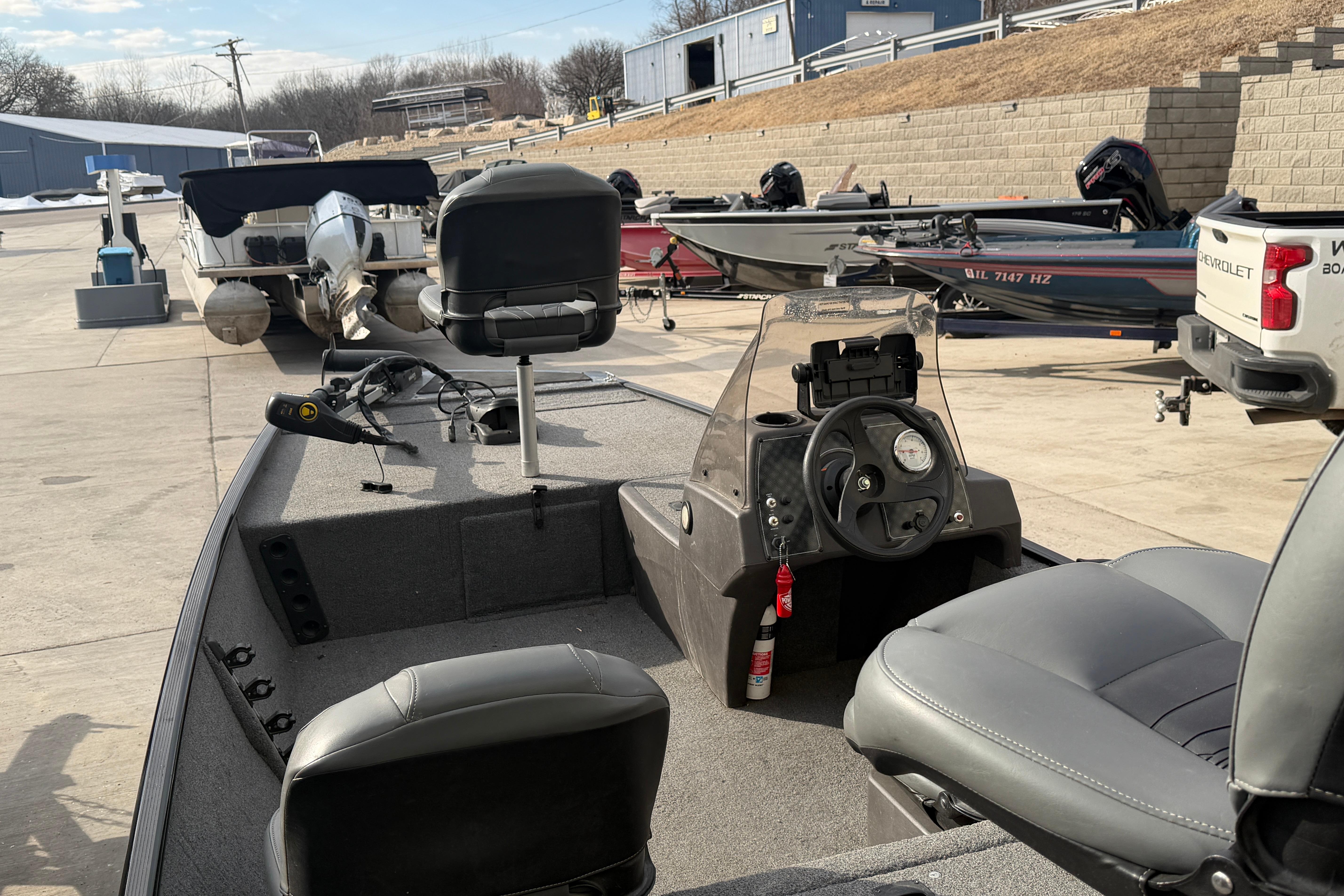 2020 Tracker Bass Tracker Classic XL boat with seating and steering console in a marina.