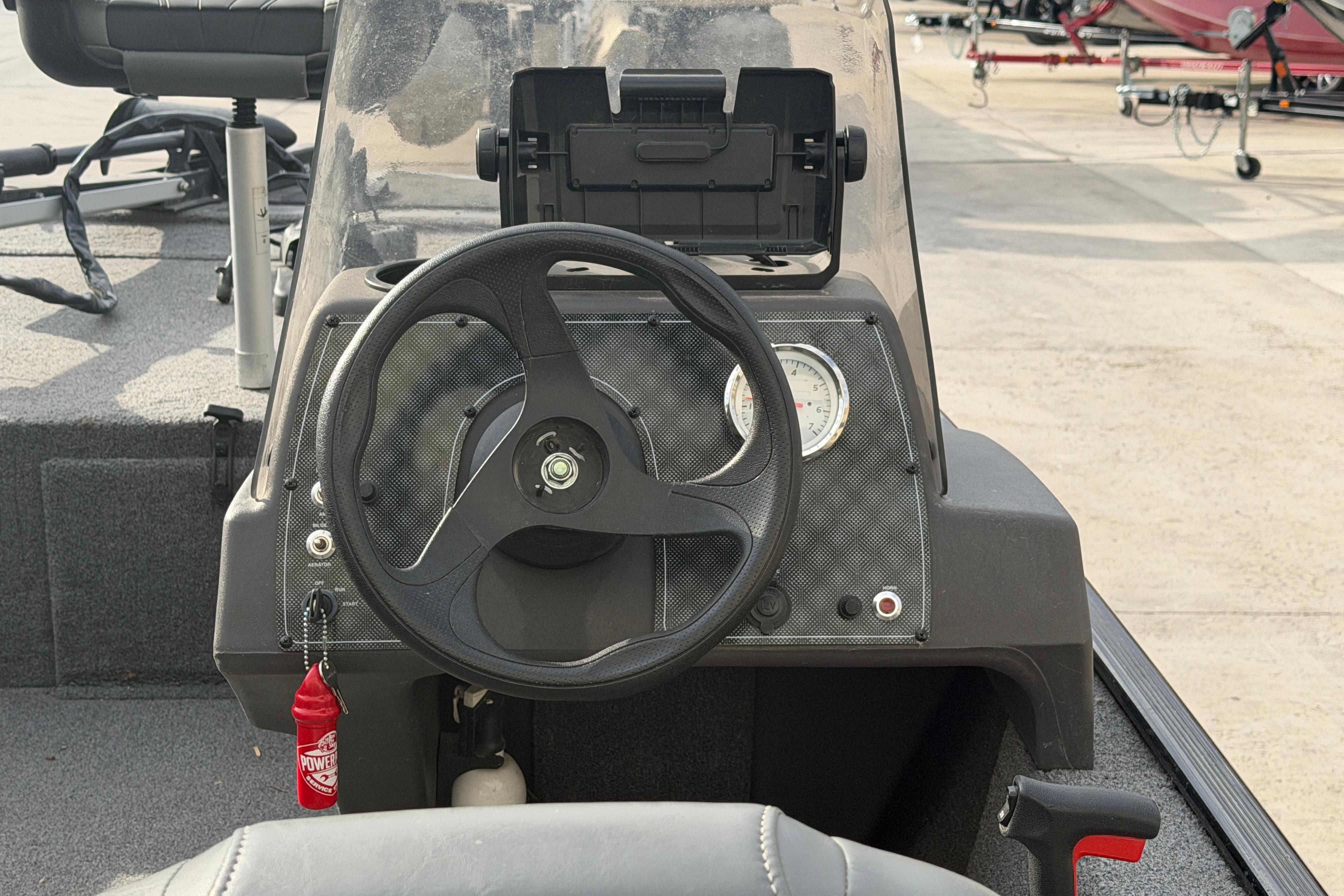 2020 Tracker Bass Tracker Classic XL boat dashboard with steering wheel and gauges.