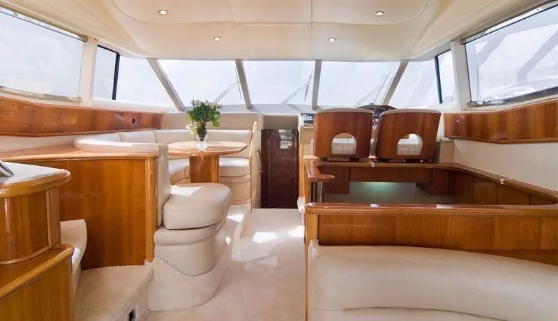  Yacht Photos Pics Luxurious interior of a 2001 Princess 56 yacht with elegant wood and leather furnishings.