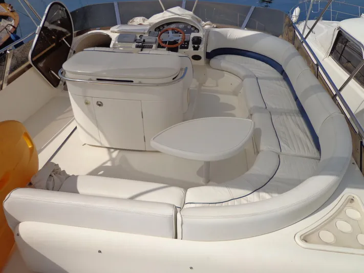  Yacht Photos Pics Luxurious 2001 Princess 56 yacht cockpit with white seating and control panel.