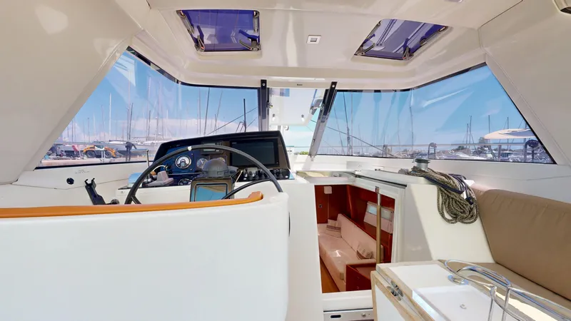  Yacht Photos Pics Interior view of 2012 Amel 55 yacht cockpit with navigation equipment and seating.