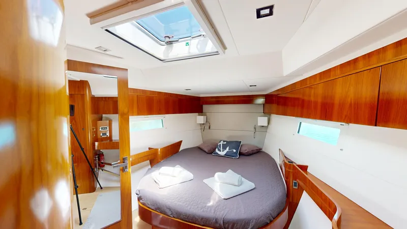  Yacht Photos Pics Luxurious cabin interior of 2012 Amel 55 yacht with skylight and wooden finishes.
