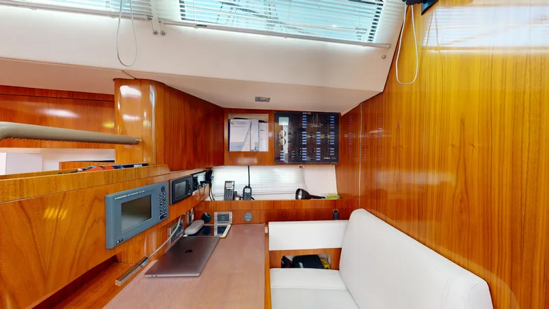  Yacht Photos Pics Luxurious interior of 2012 Amel 55 yacht with wood paneling and navigation equipment.