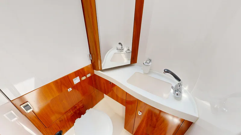  Yacht Photos Pics Luxurious bathroom in 2012 Amel 55 yacht with wooden cabinetry and modern fixtures.