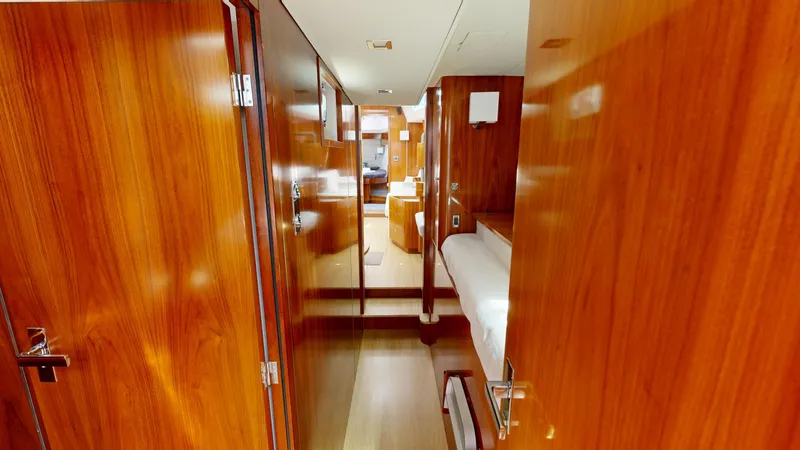  Yacht Photos Pics Luxurious wooden interior of 2012 Amel 55 yacht cabin hallway.