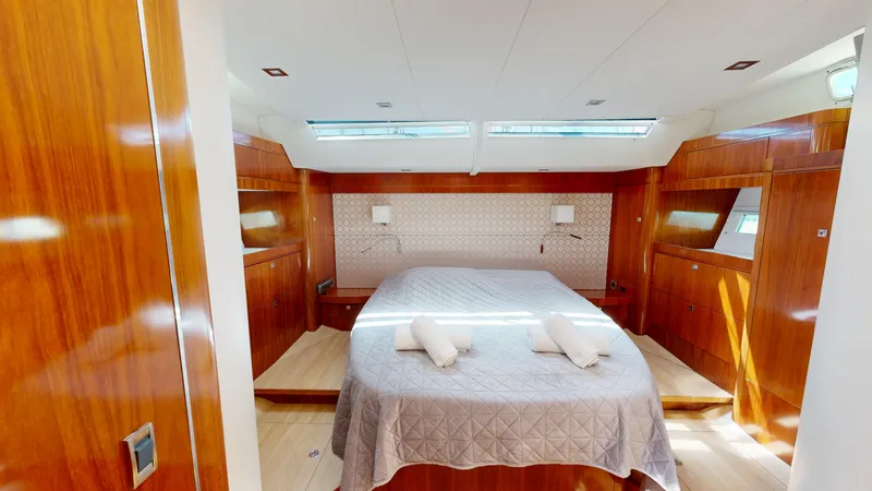  Yacht Photos Pics Luxurious Amel 55 yacht bedroom interior with wood paneling and skylights, 2012 model.