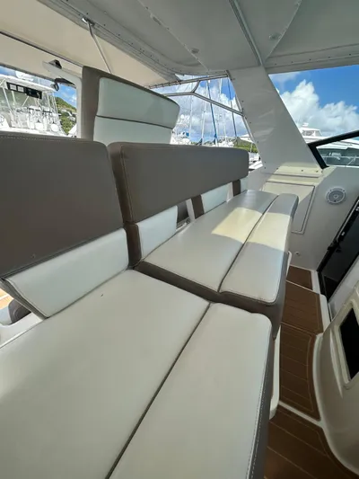  Yacht Photos Pics 2003 Tiara Yachts 4000 Express interior seating with white and brown cushions, under a sunny sky.