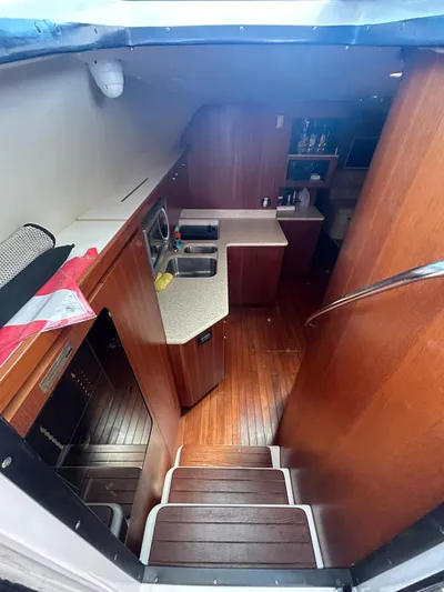  Yacht Photos Pics 2003 Tiara Yachts 4000 Express interior with wooden flooring and modern kitchen amenities.