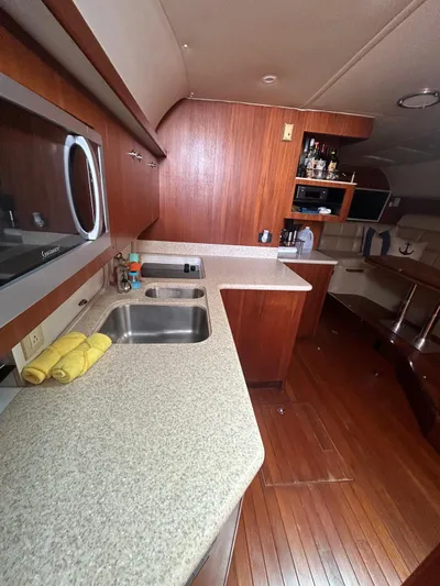  Yacht Photos Pics 2003 Tiara Yachts 4000 Express interior kitchen with wood cabinetry and dual sinks.