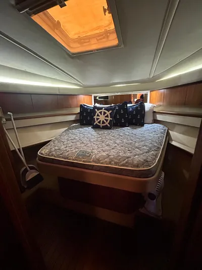  Yacht Photos Pics 2003 Tiara Yachts 4000 Express cabin with bed, nautical-themed pillows, and overhead lighting.
