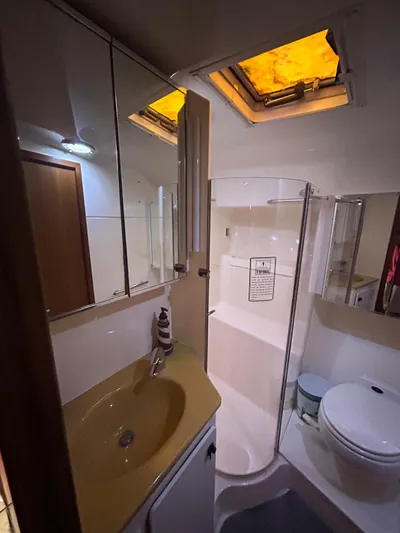  Yacht Photos Pics Bathroom interior of 2003 Tiara Yachts 4000 Express with shower, sink, and toilet.