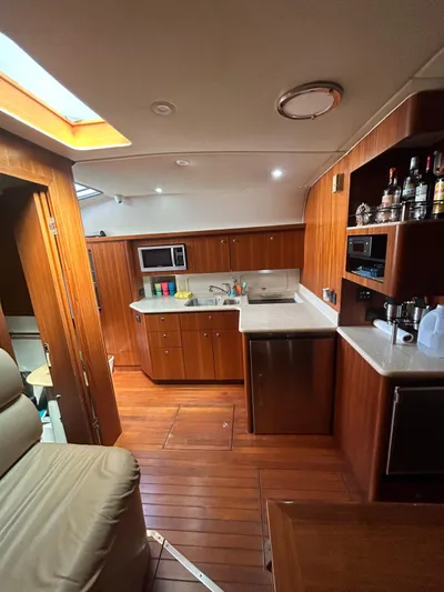 Yacht Photos Pics Interior of 2003 Tiara Yachts 4000 Express with wooden cabinetry and modern kitchen amenities.