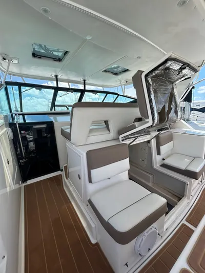  Yacht Photos Pics 2003 Tiara Yachts 4000 Express interior with white seating and wood flooring.