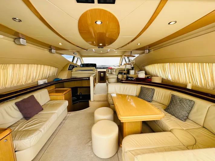  Yacht Photos Pics Luxurious interior of a 2005 Ferretti Yachts 550 with elegant seating and wooden accents.