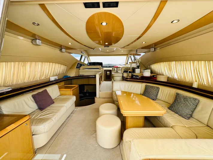  Yacht Photos Pics Luxurious interior of a 2005 Ferretti Yachts 550 with elegant seating and wooden accents.