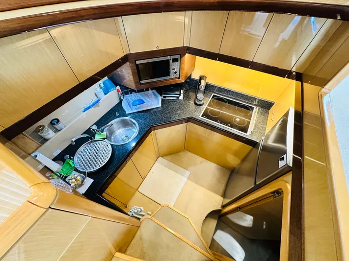  Yacht Photos Pics Luxurious kitchen interior of 2005 Ferretti Yachts 550 with modern appliances and sleek design.